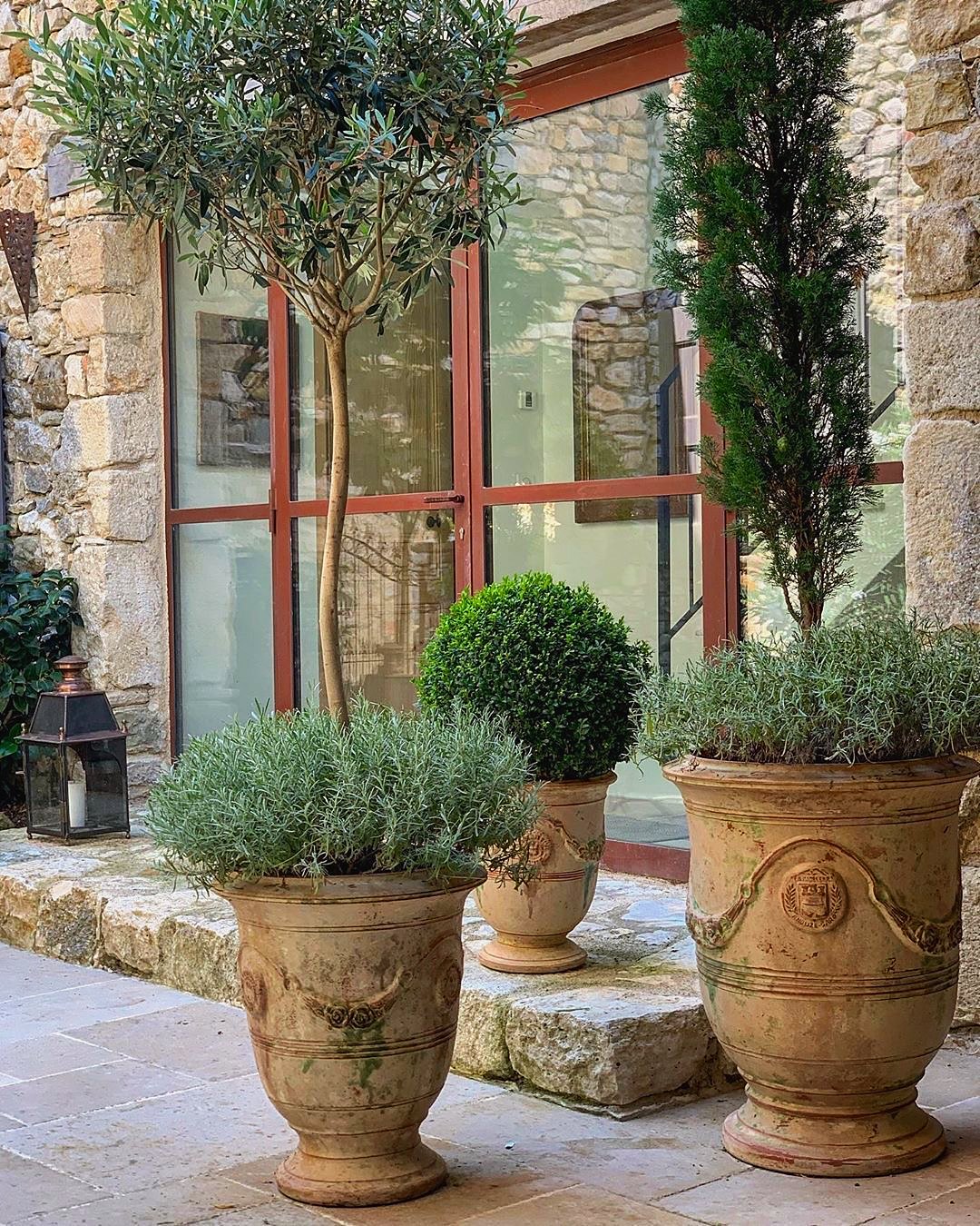 Antique Anduze garden urns in a stone courtyard