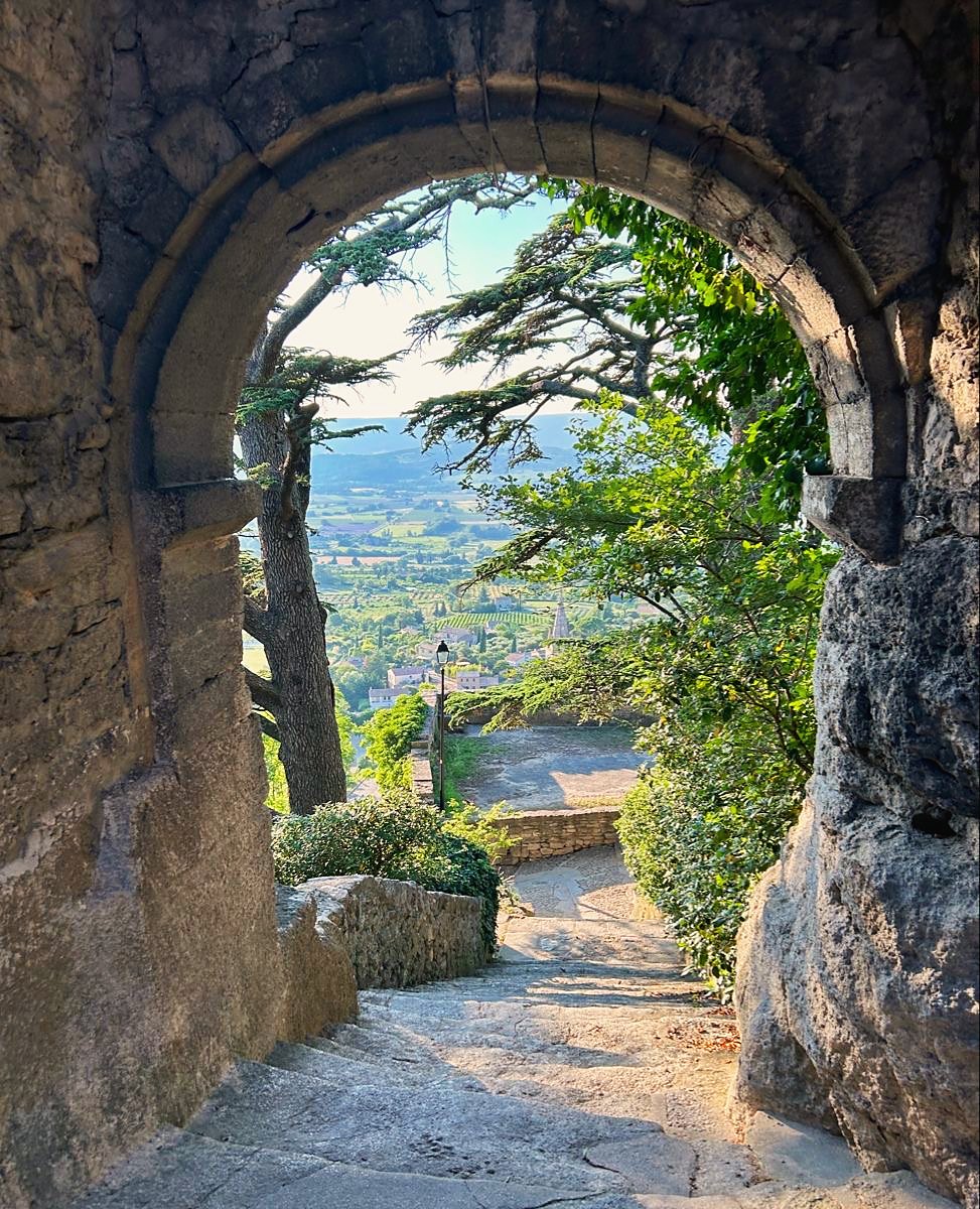 Stone archway framing the view over the Luberon valley